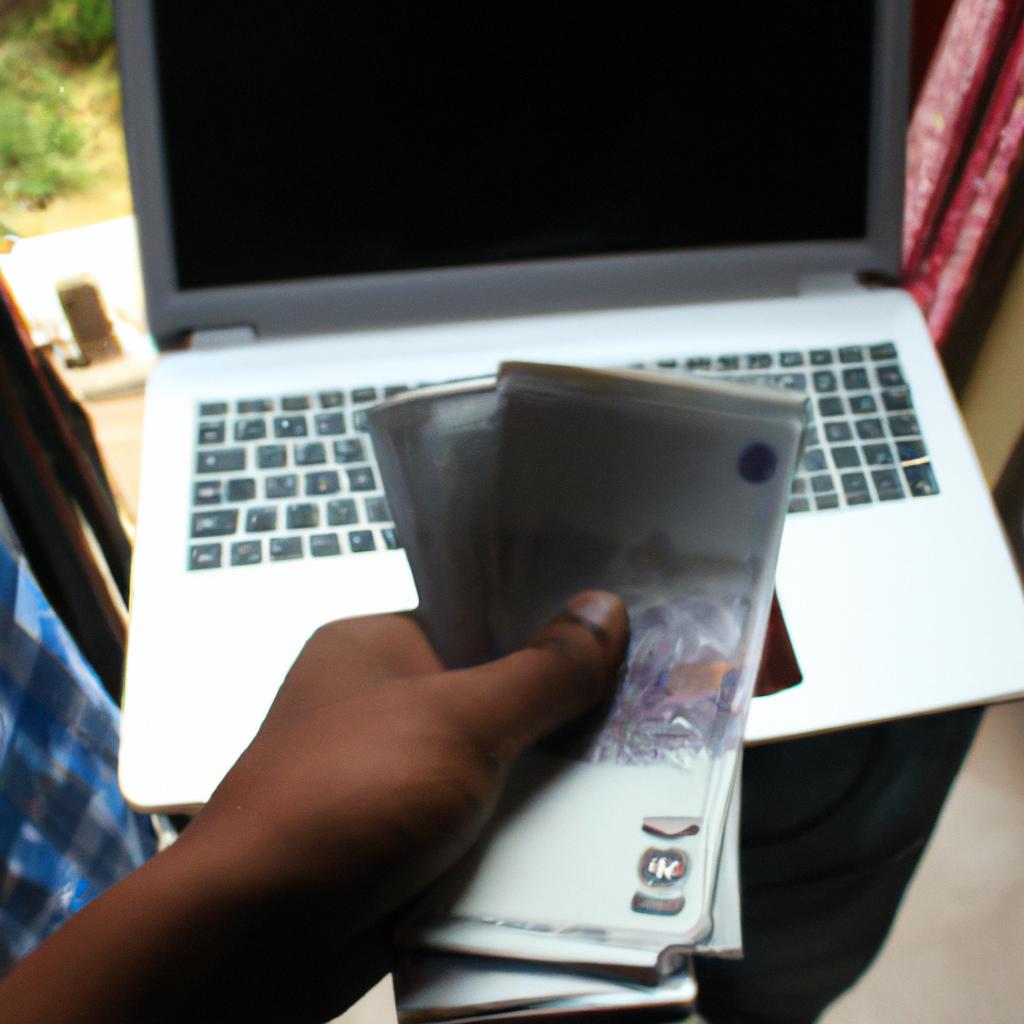 Person Holding Money And Laptop